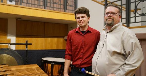 大卫·沃克(左)是bet8体育娱乐入口打击乐研究主任. Here, 他和他的儿子迈克尔在钱德勒独奏厅的舞台上合影, 他是一名打击乐手，也是ODU的学生.